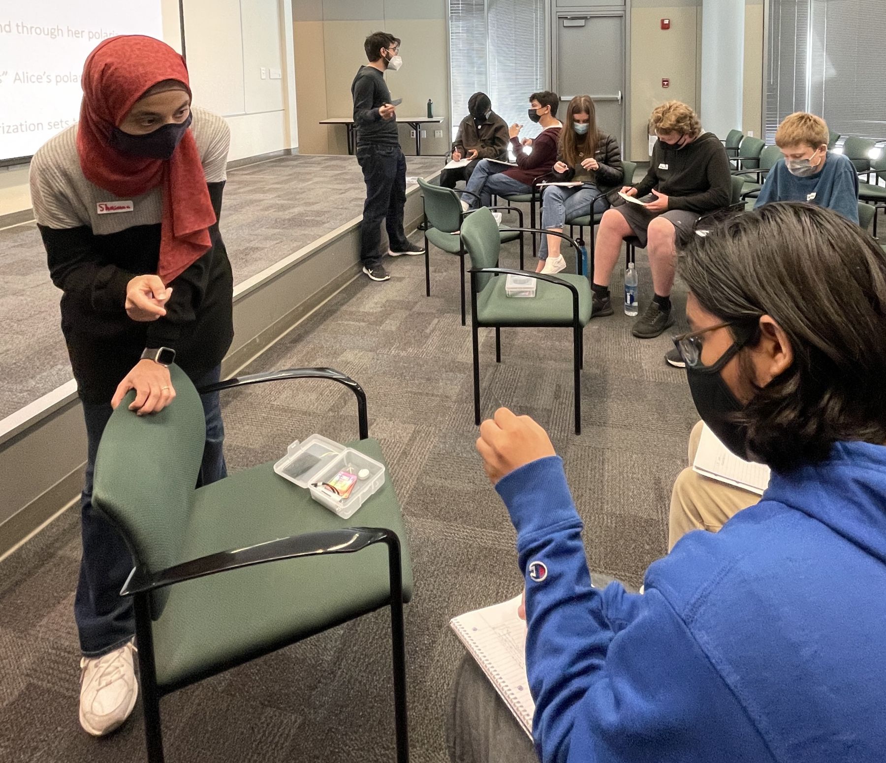 Shaimaa Azzam, postdoctoral researcher, and Kamyar Parto, graduate student, lead students through a lesson on polarization